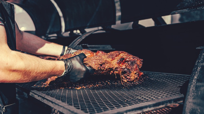 brisket being removed from smoker