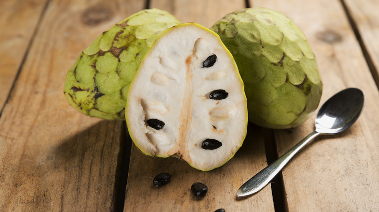 cherimoya on table with a spoon