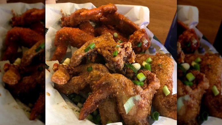 A basket of sauced and dry rubbed chicken wings at Crisp in Chicago