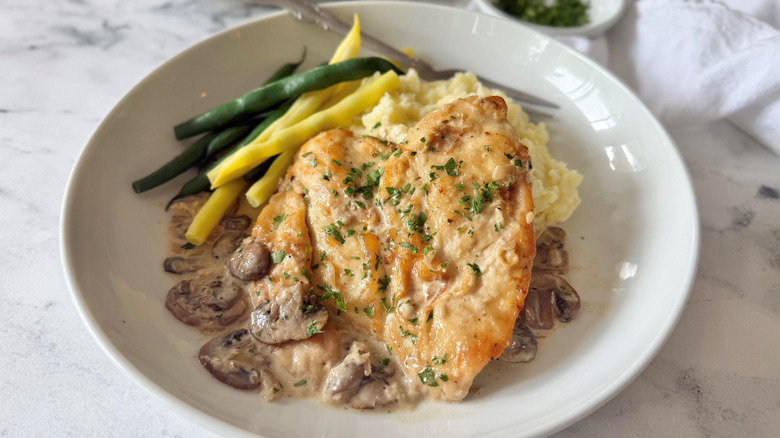 Chicken scallopini with mushroom cream sauce serving on plate