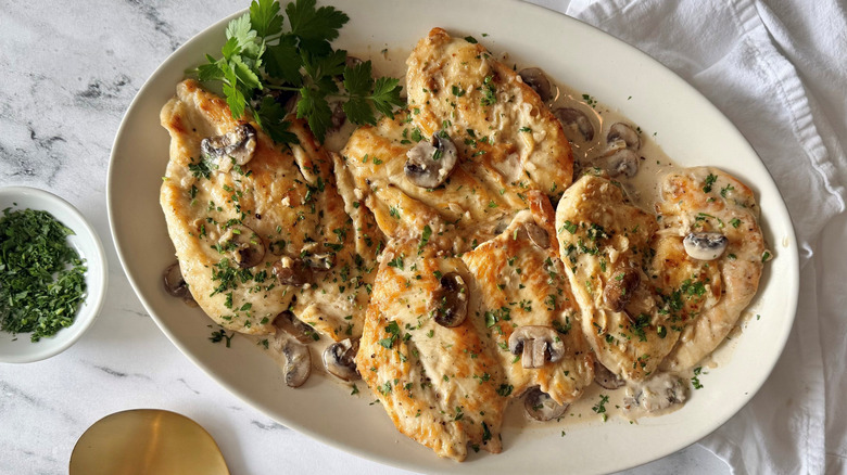 Chicken scallopini with mushroom cream sauce on serving platter