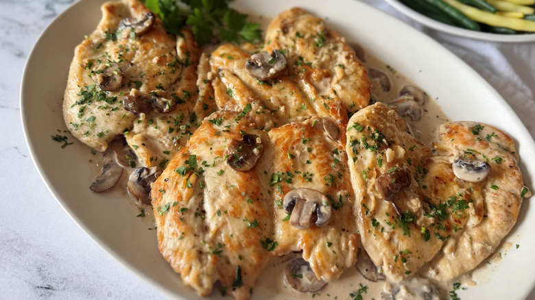 Chicken scallopini served with mushroom cream sauce and parsley