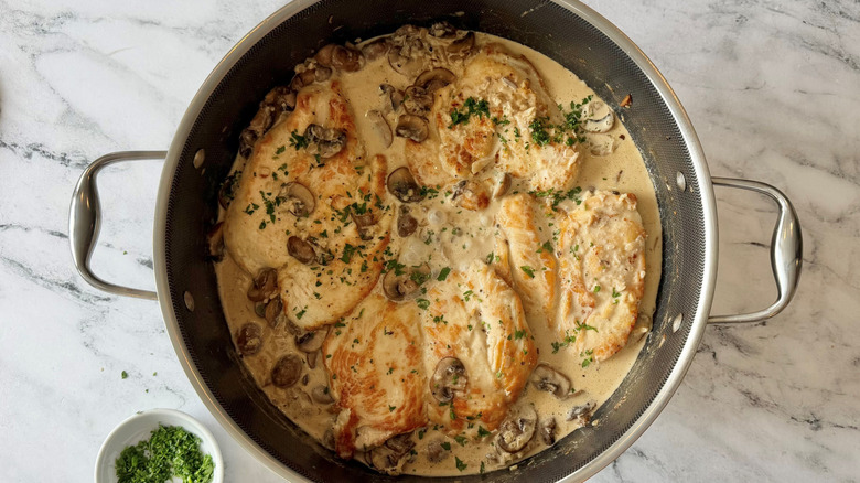 Chicken scallopini with mushroom cream sauce in pan