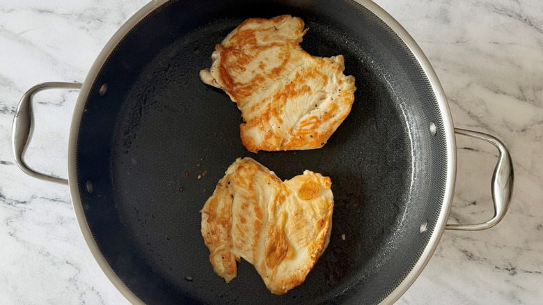 Browned chicken breasts in pan