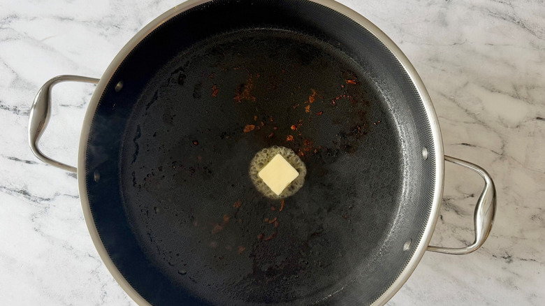 Pat of butter melting in pan