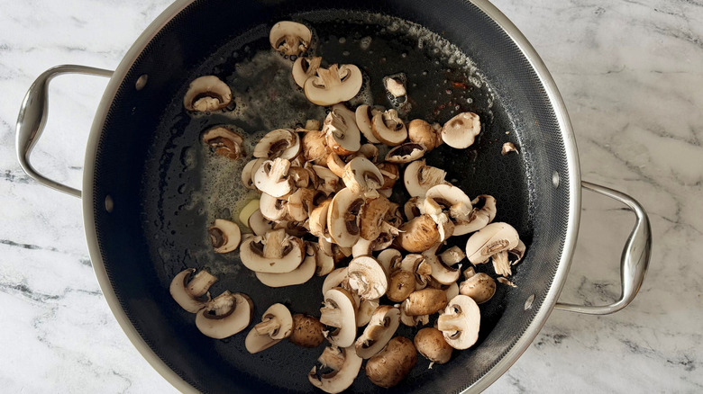 Sliced mushrooms in pan