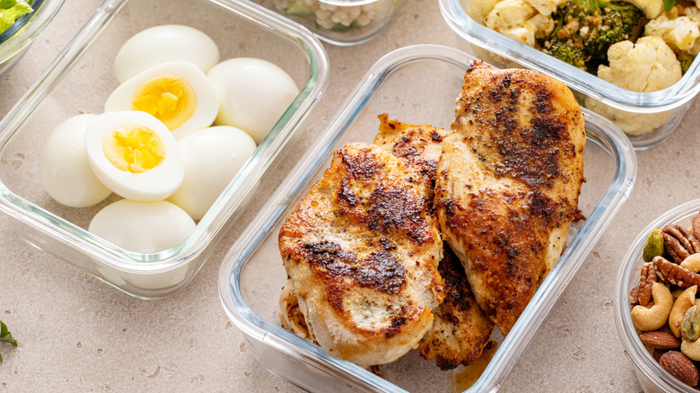 Meal-prepped chicken and eggs in containers