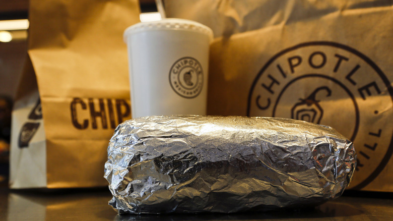 bags of chipotle food, to-go cup, and wrapped burrito