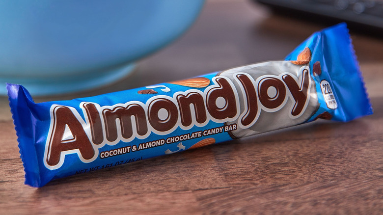 Close-up of an Almond Joy bar sitting on a woodgrain surface