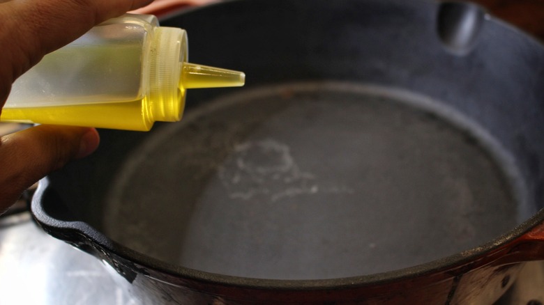 adding oil to pan