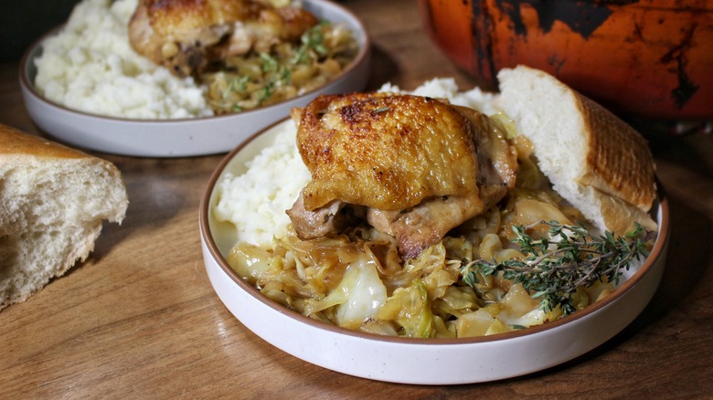 plate of chicken with bread and potatoes