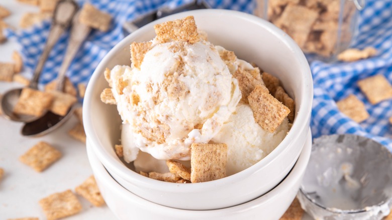 Scoops of ice cream in white bowl with Cinnamon Toast Crunch cereal on top