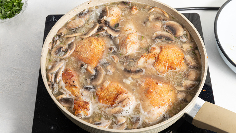 chicken and mushrooms in pan
