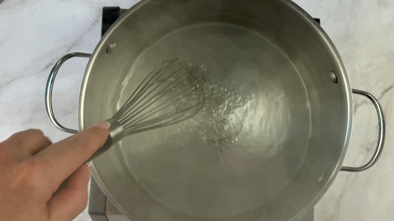 whisking water in pot