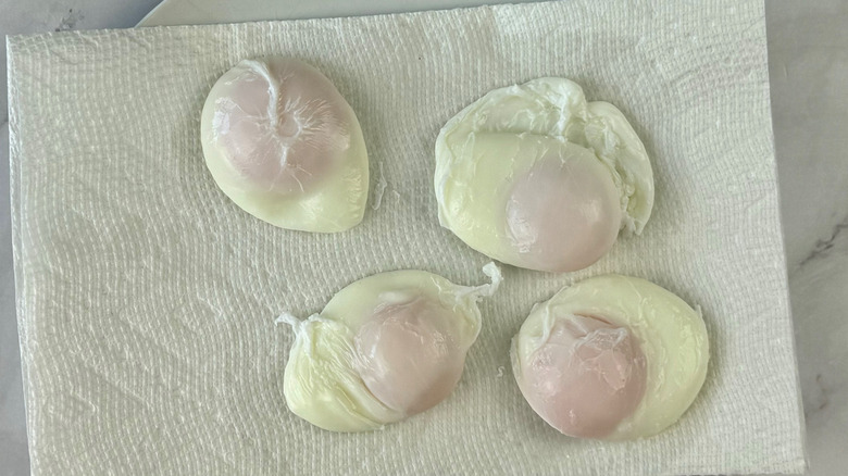 poached eggs draining on paper towel