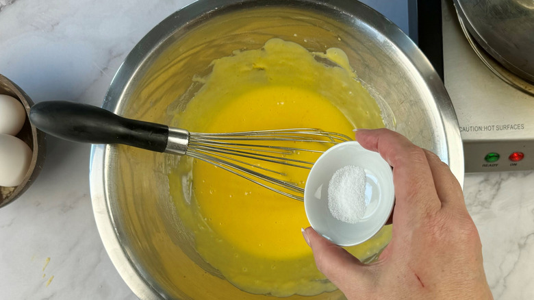 whisking salt into hollandaise sauce