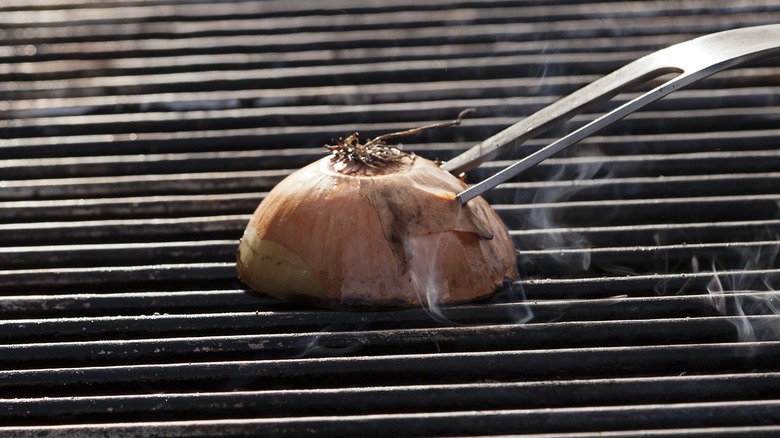 onion cleaning a hot grill