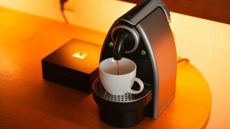 Nespresso machine pouring coffee into a cup