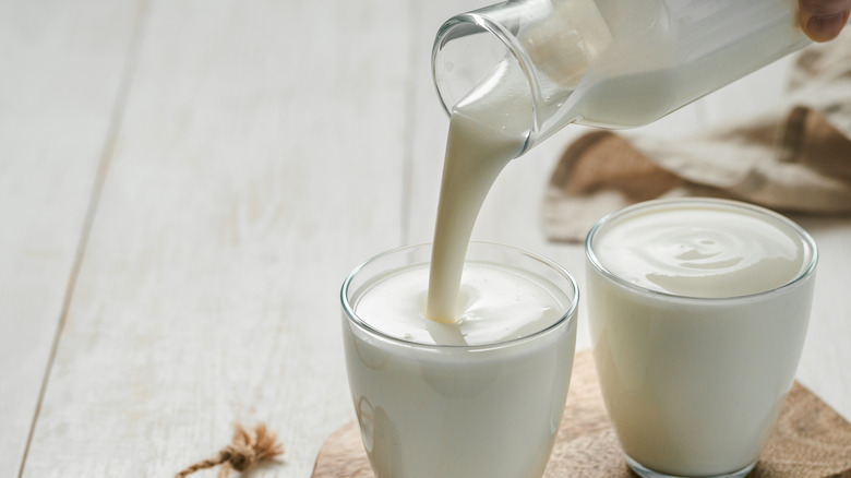Buttermilk poured from glass bottle