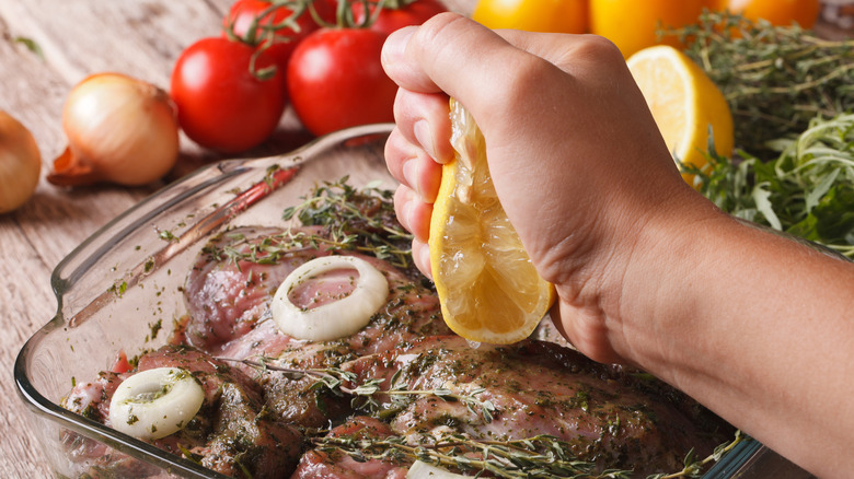 squeezing lemon over meat
