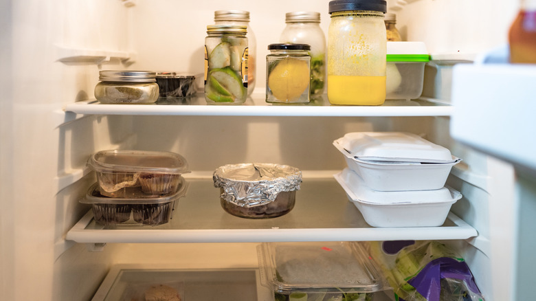 View inside a fridge with leftovers and various food items