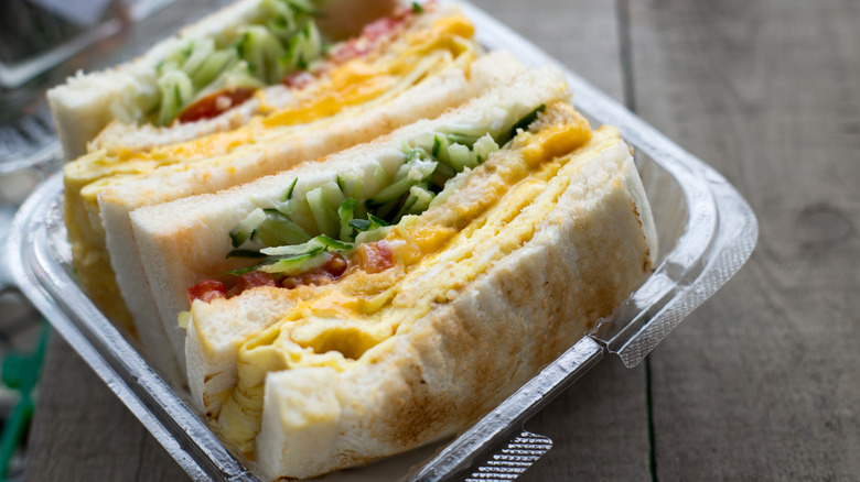 Egg and veggie sandwich in plastic to-go container