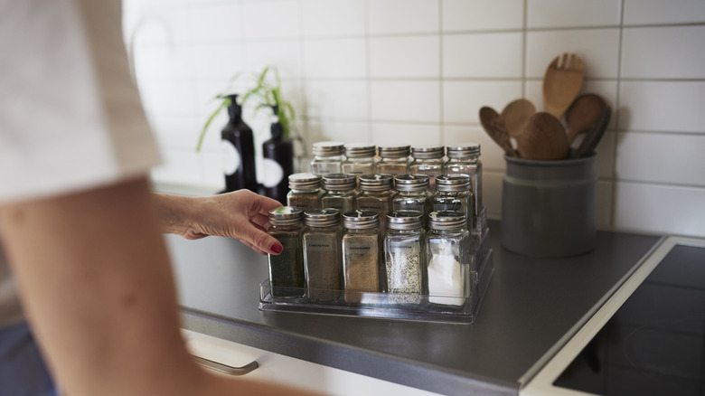 person organizing spices