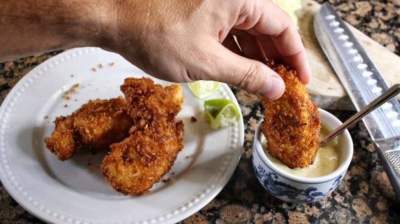 dipping chicken tender in sauce