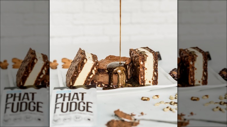 Fudge poured over ice cream cookie sandwiches