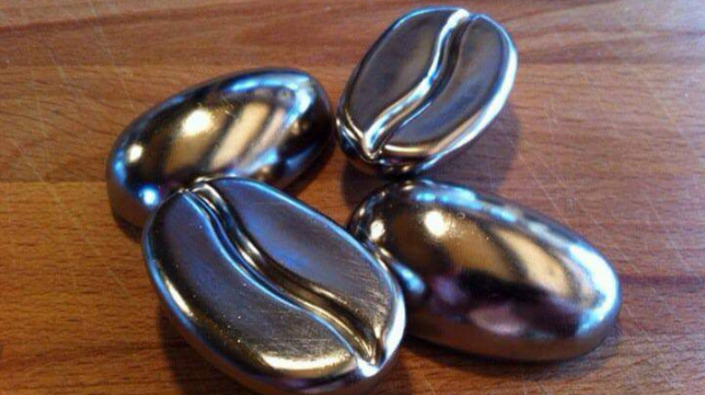 Four Coffee Joulies sit on a wooden table