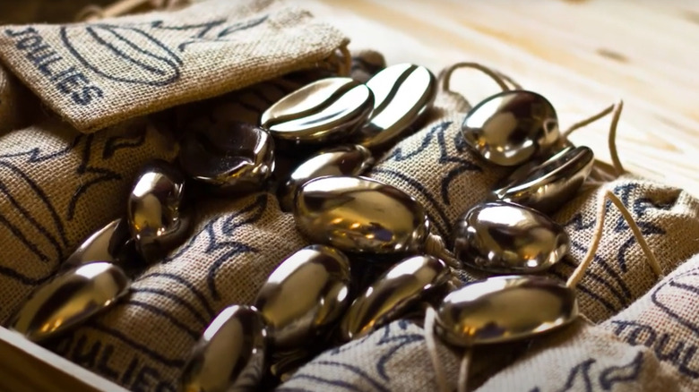 Coffee Joulies rest on top of branded burlap bags
