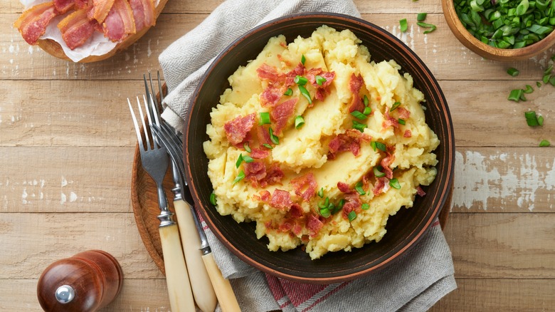 Mashed potatoes topped with bacon and green onions