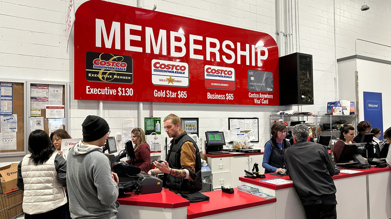 Customers gathered around a Costco membership services desk