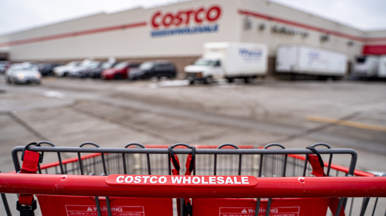 Shopping cart pointed toward a Costco warehouse