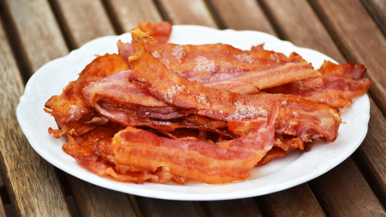 Crispy bacon resting on plate
