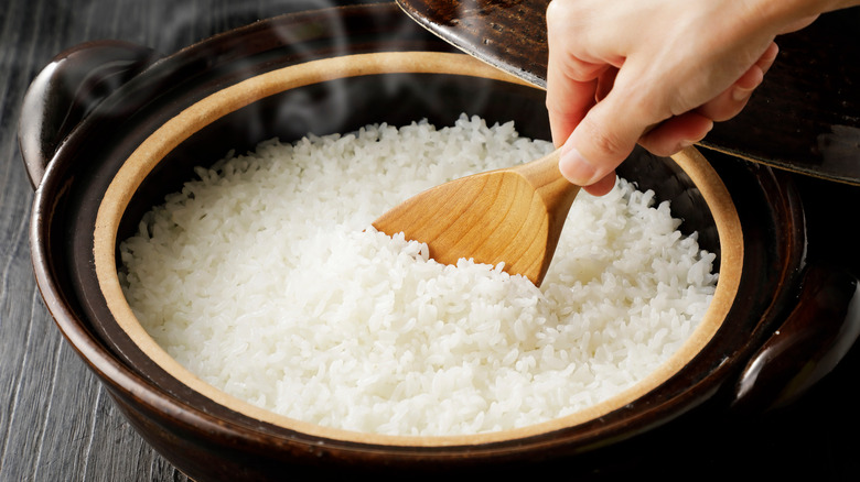 scooping rice out of pot