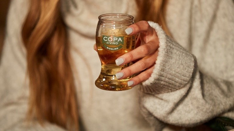 Woman holding a glass of Copa di Vino