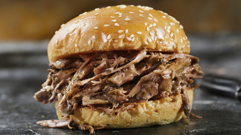 Roast beef sandwich served on cutting board.