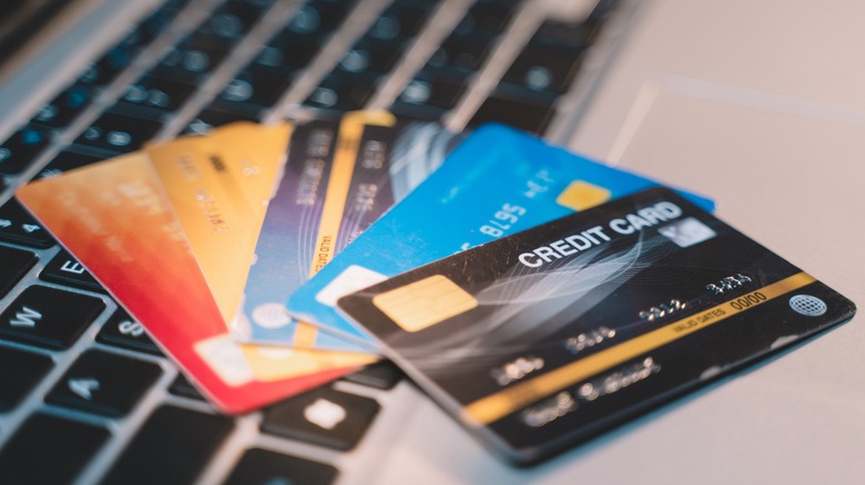Assorted credit cards fanned out on a keyboard