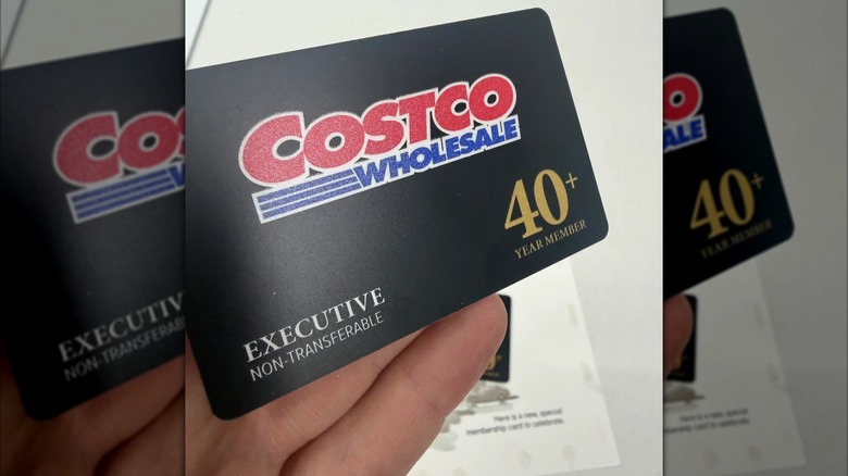A hand holds a special Costco membership card.