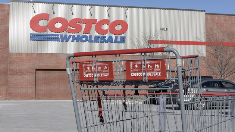 exterior of costco warehouse with costco wholesale shopping cart in foreground