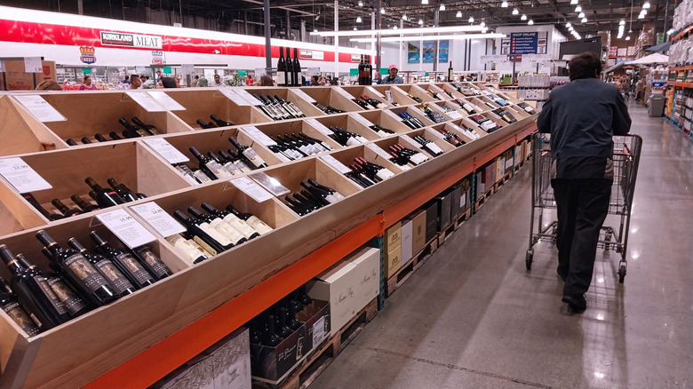 shopper walking past wine stock at Costco
