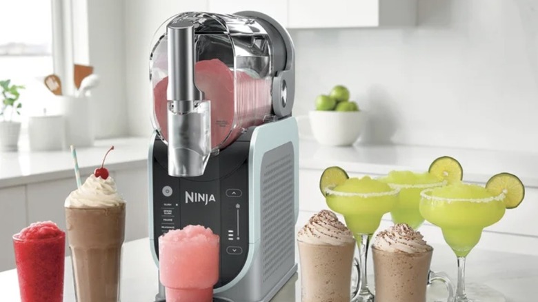 Ninja SLUSHi on a counter with various frozen drinks
