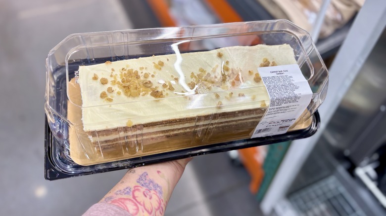 Holding Costco cake in the store