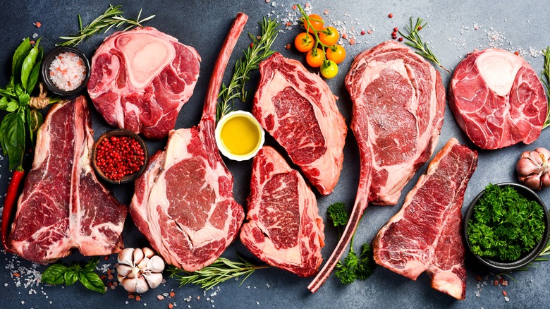 Different cuts of steak with various herbs and seasonings