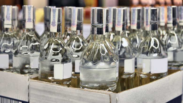 Unlabeled bottles of vodka in a store.