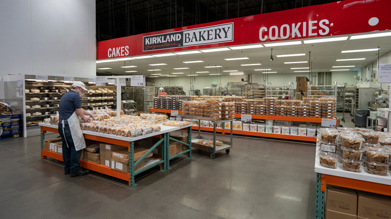 A Costco bakery in a store in Oregon has a worker organizing bags of bagels