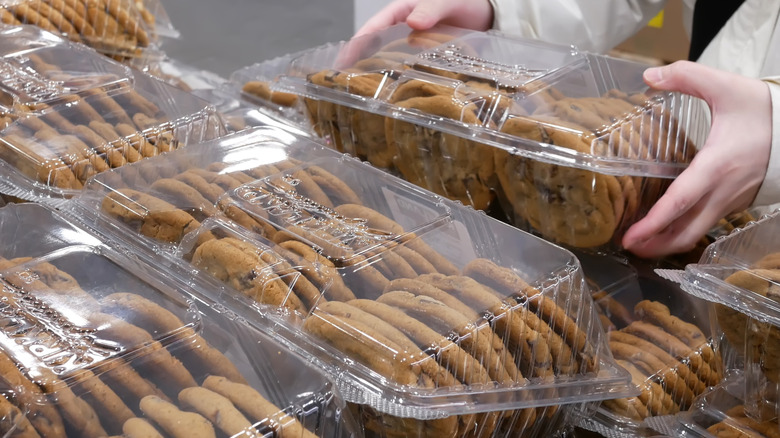 Someone picking up a package of cookies in a Costco store