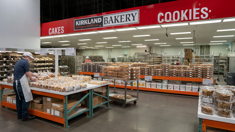 A Costco employee stocks bagels in the bakery section of the warehouse