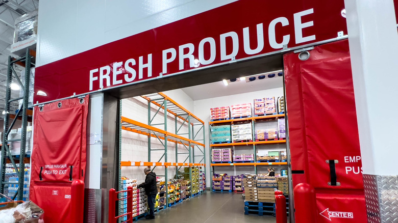 Fresh Produce can be read overhead an entrance to a Costco produce department